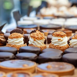 A delectable array of gourmet pastries and desserts featuring creamy, chocolate, and nut toppings, perfect for indulgence.