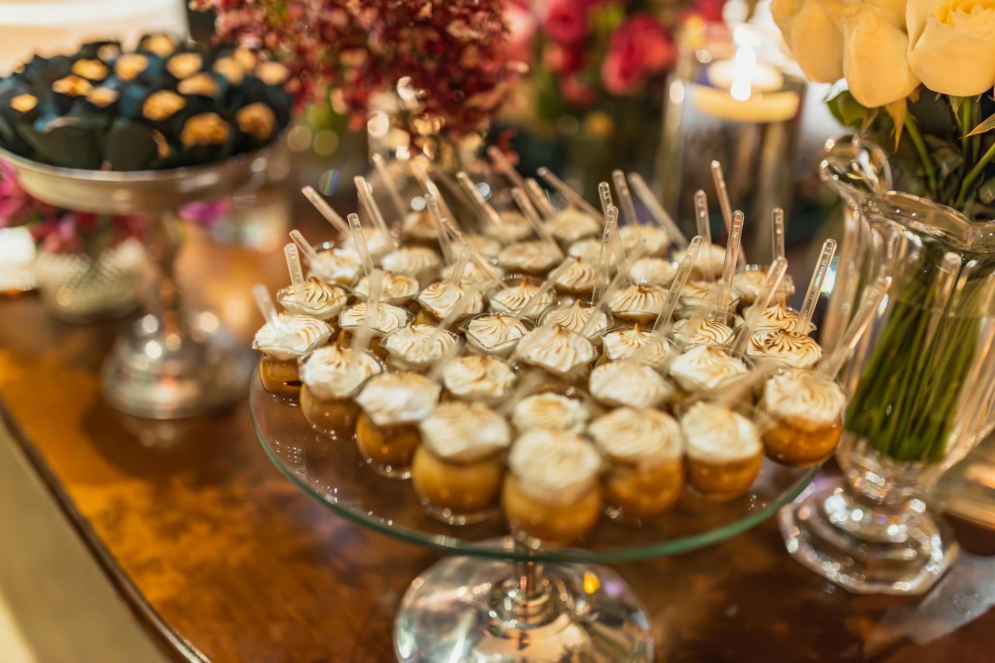 Beautifully arranged dessert table featuring a variety of sweets and flowers, perfect for events.