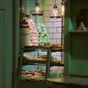 Cozy Istanbul bakery showcasing an array of colorful pastries and sweets through a rustic window.