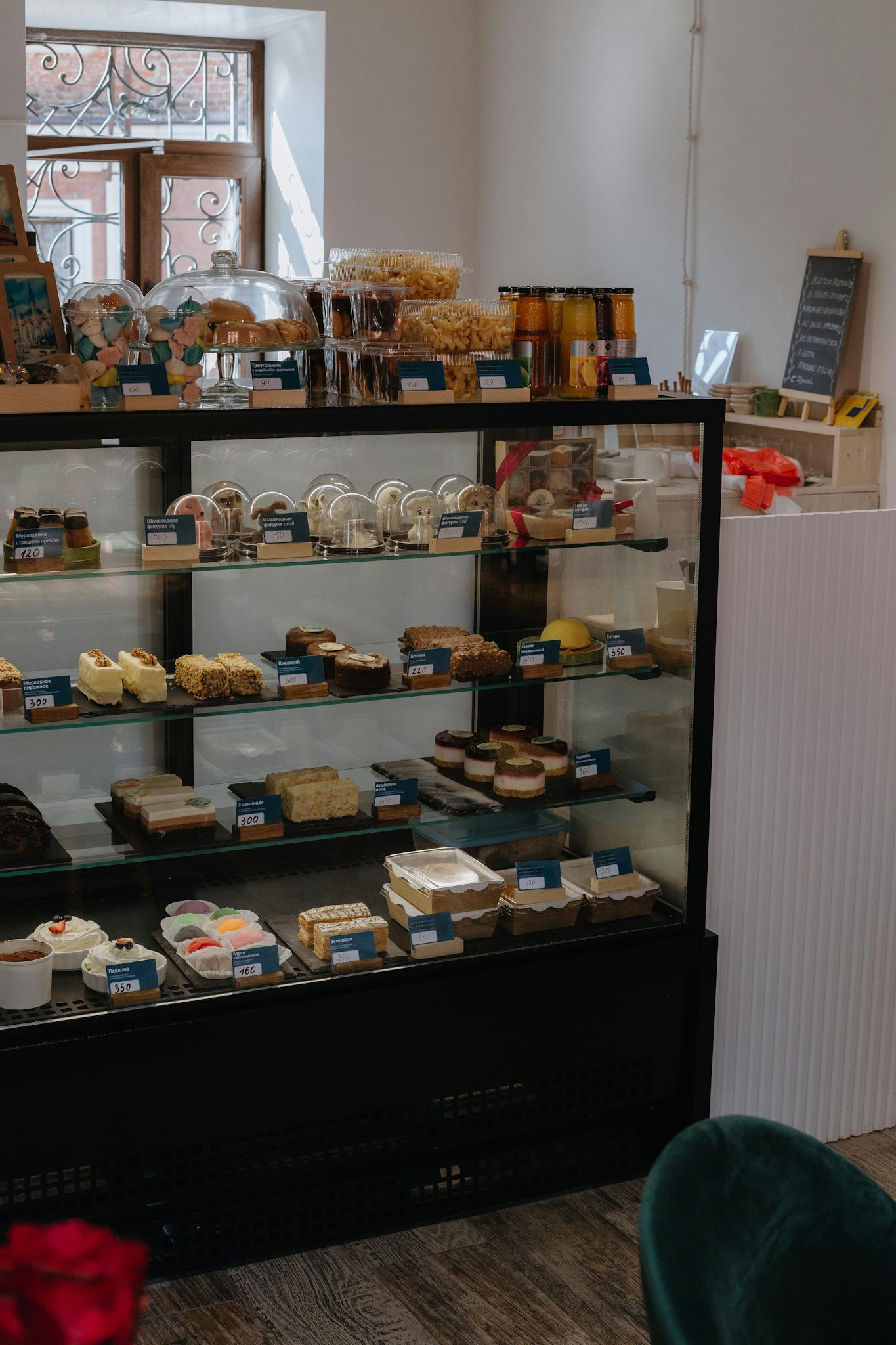 Tempting array of pastries and sweets displayed in a bakery's glass showcase.
